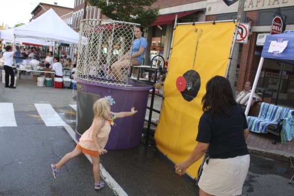 Seven-year-old southpaw Piper Fecteau throws an on-target ball to dunk volunteer Mackenzie Flessas.