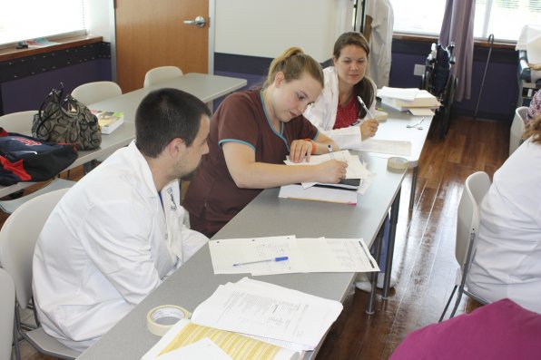 Medical students (from left) James Houlne, Angela Skinner and Kayleigh Clark go over an assignment in class.