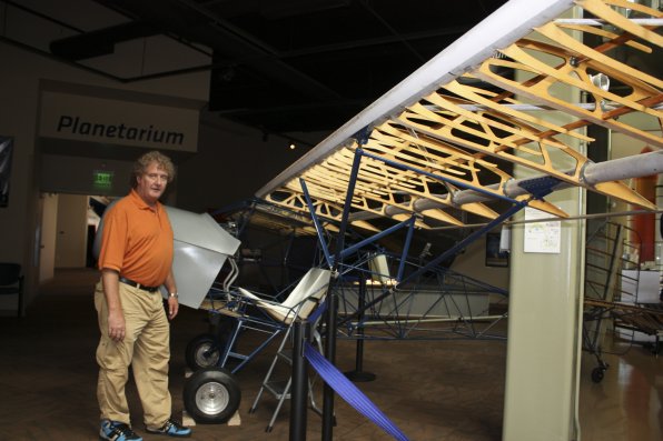 David McDonald, the center’s director of education, stands with the shell of an airplane.