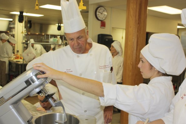 Chef McIntosh instructs senior Josie Lemay. Students work hands-on in a kitchen environment five days a week.