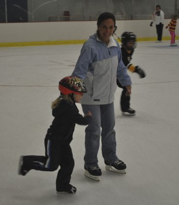 Denise Gridley helps Rachel Gridley, 6, make her way around the rink.