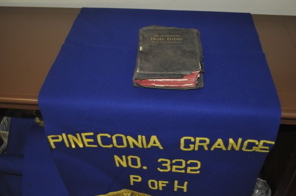 The first bible used by the grange in 1914 sits atop the group’s colors.