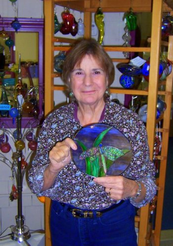 Annette Burgess shows off a pane of stained glass with a butterfly “fossil” trapped inside. Isn’t that lovely!