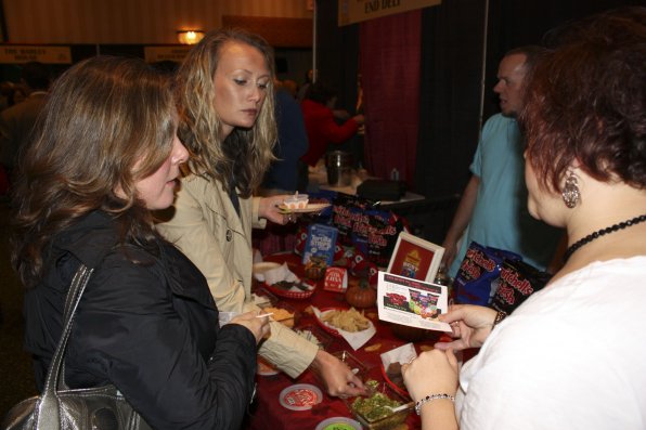 Tara Chandler and Katherine Tomlinson scoop some salsa as Nicole Kelley of Mitchell’s Fresh Salsa gives them the specifics.