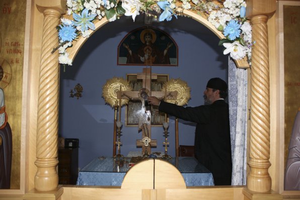 Father Alexander lights a flame on the altar.