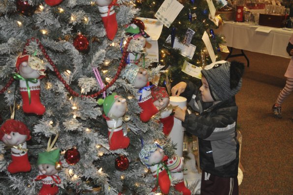 Jack Clark, 3, places his ticket for the “Stocking Stumpkins” tree donated by Billie Dionne and Mary K. Northrup.