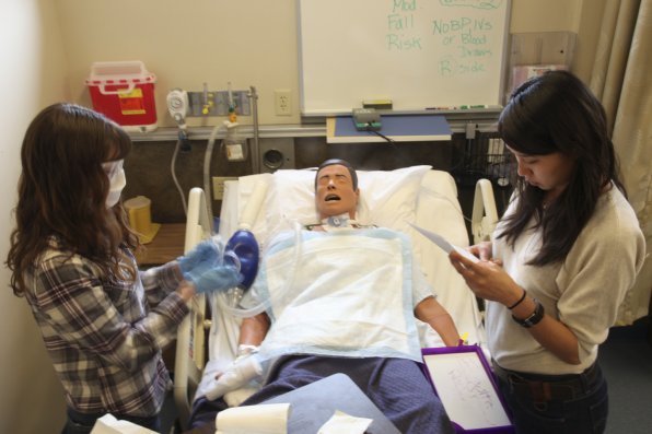 Mallon and fellow first-year nursing student suction the tracheostomy on their training mannequin. "Basically, we do this to dummies before we do it to a real person," Sun said.