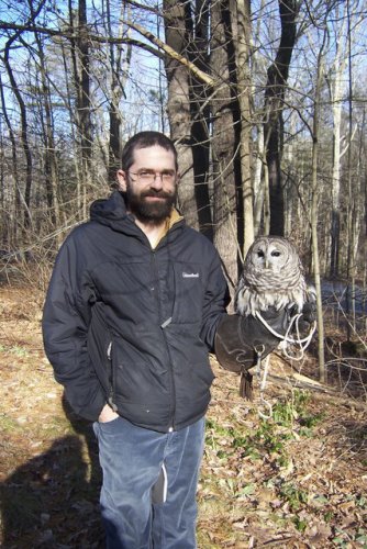 Kevin Wall, educational director at the New Hampshire Audubon's McLane Center in Concord, holding a barred owl. If you listen closely, you can hear him - the owl, not Wall.
