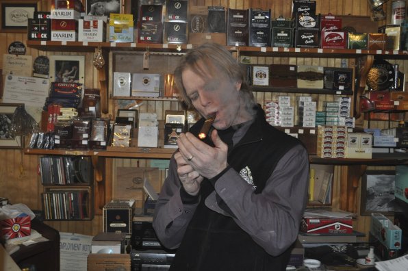 Eric Kilbane sparks up a stogie at Castro’s Back Room.