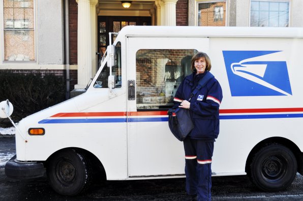 Julie Richtarik stands outside the driver’s – er, passenger – side of her trusty mail truck.