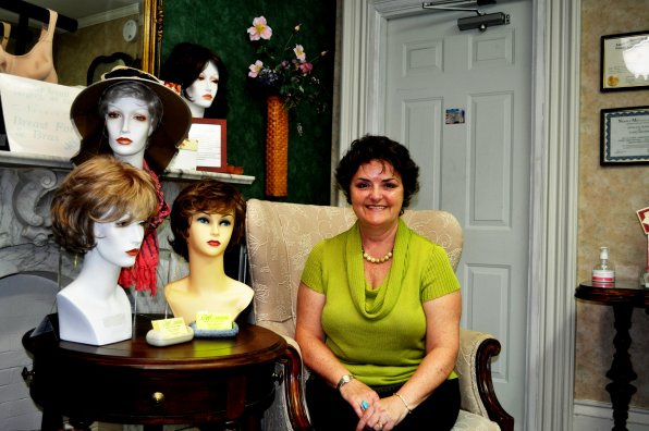 Stella Hogan (right, green shirt, human person whose head is attached to her body) and some of her finest wigs. We’d look great in a bob, don’t you think?