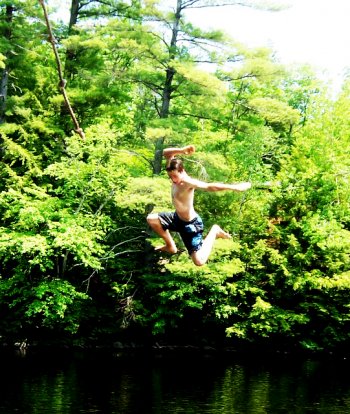 Arthur Anderson flies off a rope swing into the Contoocook.