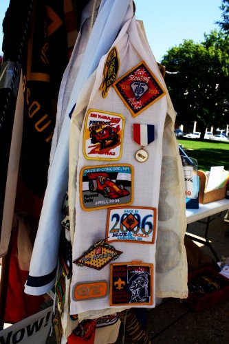 A sash adorned with a variety of merit badges.