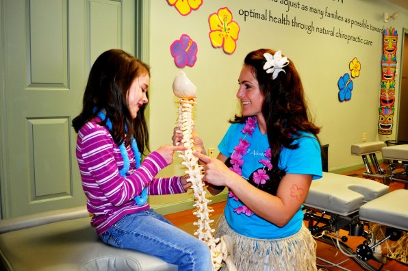 Dr. Stephanie Mills drops some spinal knowledge on a long-time chiropractic enthusiast, 6-year-old Taylor Ahearn.