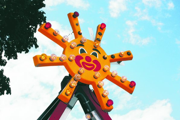 A friendly-faced carnival ride looms over Main Street during the 2011 Market Days.