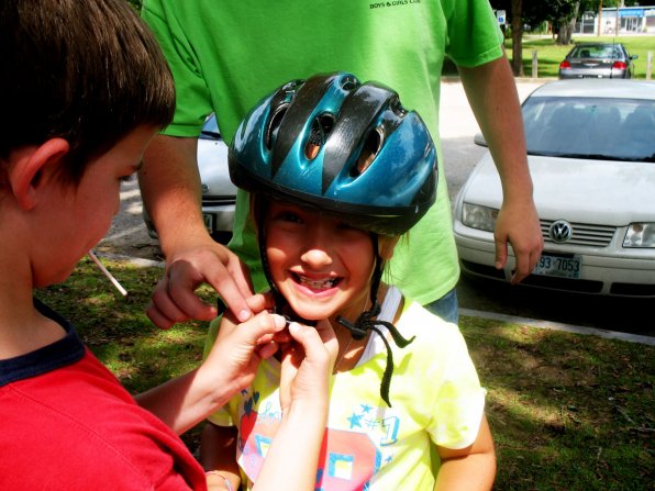 Paul DiFazzio properly fastens Cassidy Piroso’s helmet during a recent bike safety training.