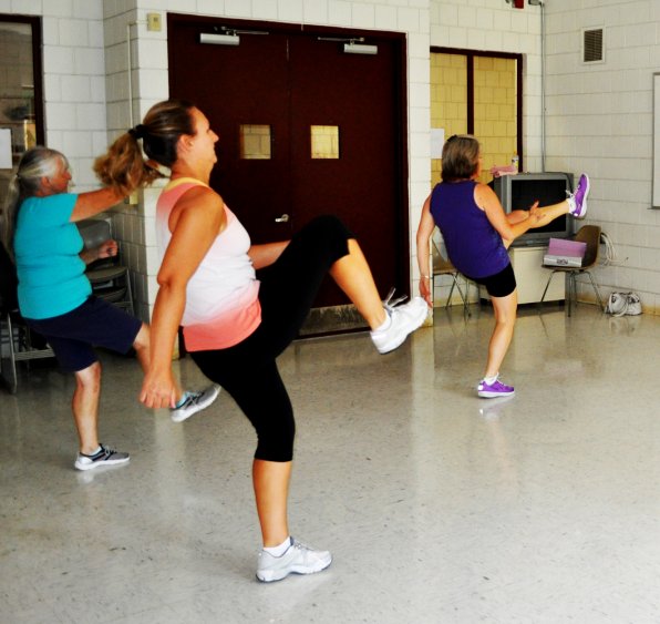 Karen MacGregor, Christy Spaulding and Kathy Lang get down during a Zumba class at the General Services Department.