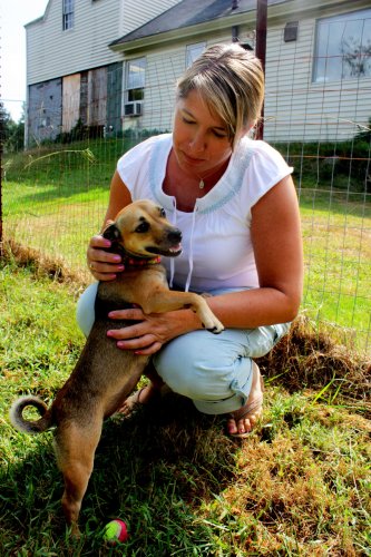 SPCA employee Shannon Camara spends a little time in the yard with Jasmine, an energetic little doggie dynamo.