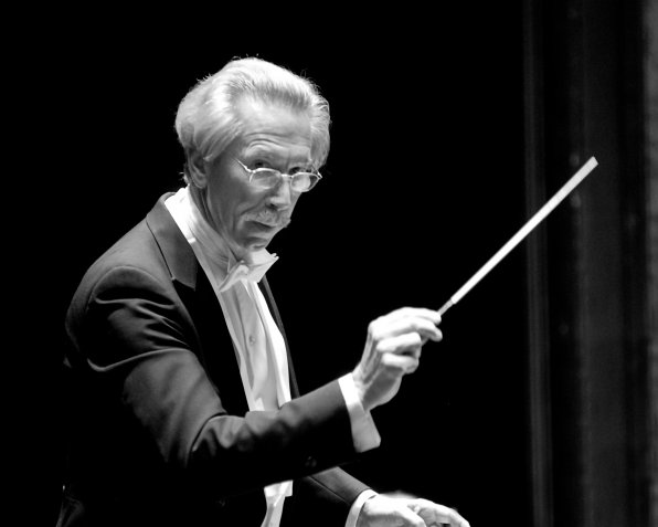Robert Babb, co-founder and music director of the Granite State Symphony Orchestra, conducts (and tosses a glance toward the camera).
