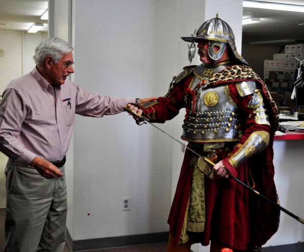 John Holman, owner of Evans Printing, makes sure Eryk Jadaszewski’s armor is legit. The sword sure looks to be!