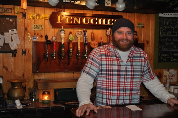 John Steiner mans the bar at Penuche’s, but don’t ask him to get up on it and dance – he’s not into it.