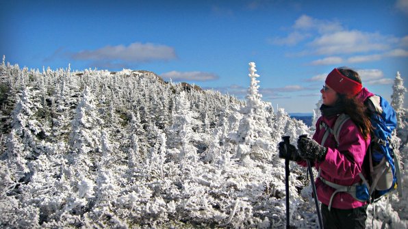 Janelle Mylott surveys a snowy Shelburne Moriah Mountain.