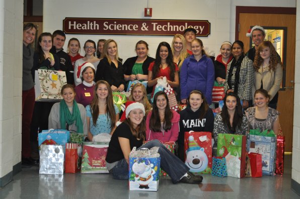 Members of Sharon Bean's Health Science and Technology classes at the Concord Regional Technical Center at Concord High School pose with Bean, Pattie Hayes of Home Instead Senior Care and the plethora of gifts they purchased for seniors.