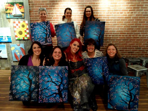 Vanessa Leigh (center) with some satisfied customers after a night of painting at Muse Paintbar.