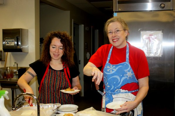 Zonta Club president Susan Lombard (right) prepares to serve up some food at the Friendly Kitchen.