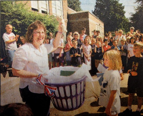 Music teacher Elaine Hashem (seen here collecting time capsule goodies on the front page of the June 20, 2002, Monitor) kept the capsule safe for 11 years – without peeking! She was thrilled with the capsule unveiling. “It was great, it was wonderful,” Hashem said. “The kids who would appreciate it were the ones that were here tonight.”