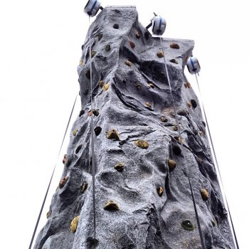 A climbing wall, courtesy of Evolution Rock and Fitness, looms over Main Street.