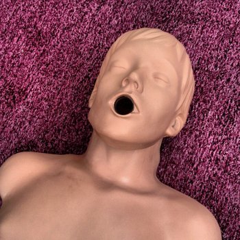 A CPR dummy on hand for a demonstration puckers up for a smooch. Do we smell a Missed Connection?