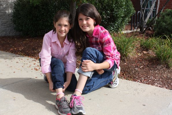 Grace and Lauren Simmons proudly sport pink anklets in honor of their grandmother, Suzanne, who is fighting breast cancer. The family will take part in Sunday’s Making Strides walk.