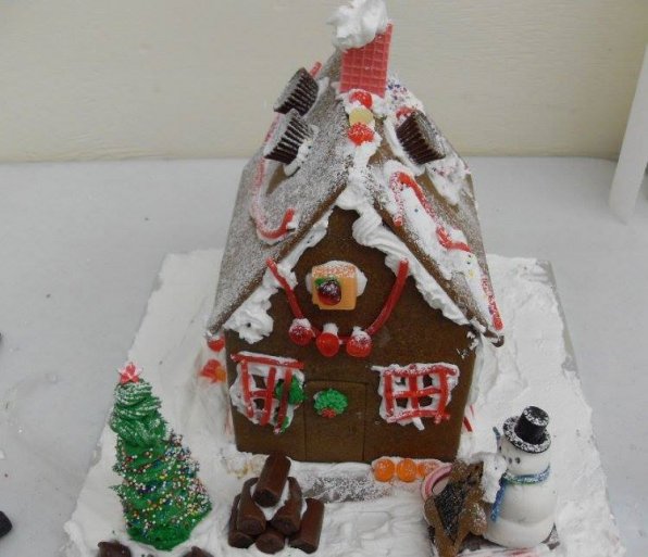 A chimney with billowing smoke and a snowman kissing someone? (children’s workshop).