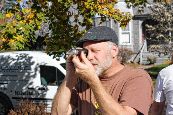Mike Curley looks through a refractometer.