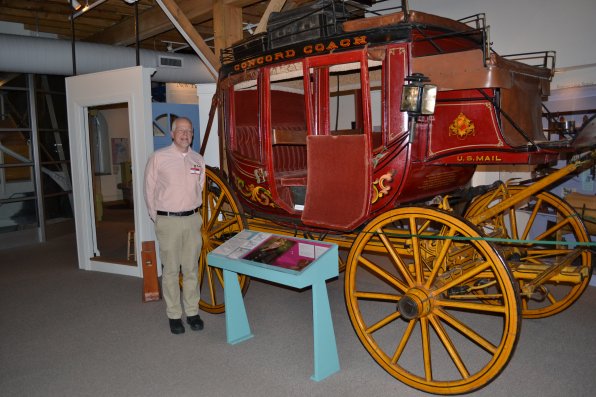 We tried to get the New Hampshire Historical Society’s Director of Collections and Exhibitions Wes Balla to take us for a ride in the Concord Coach, but apparently that is against the rules so instead he agreed to stand next to it for a photo.