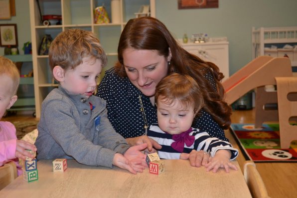Owner and executive director of the Tot Spot, Sally Wuellenweber, plays blocks with Trip Combs and her daughter, Simone Wuellenweber-Gegas.