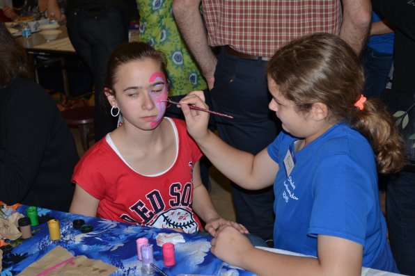 Ally Cagle gives Sarah Ripel some flashy face paint. 
