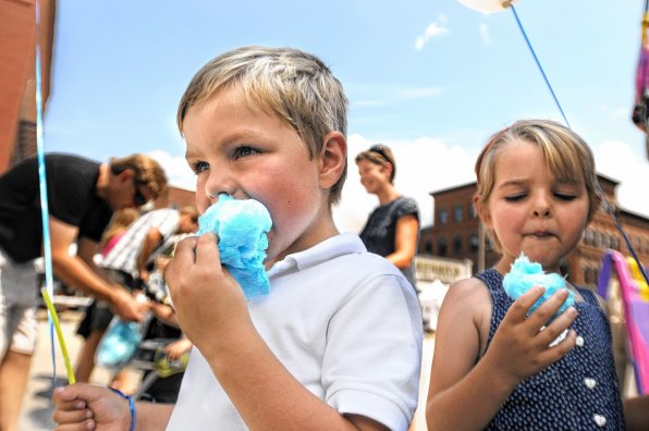 Max Bishop, 4, left, shares a bag of cotton candy with his sister, Louise, 5, during Market Days.