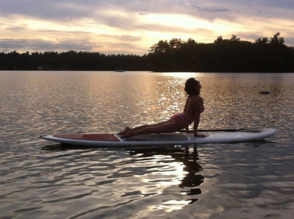 Paddle board yoga looks super relaxing – assuming we can take a boat safely out to the paddleboard.