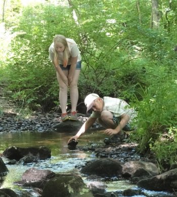 We’re not quite sure what’s in that stream, but it sure is attention- grabbing for a couple of future scientists at the N.H. Science Camp.