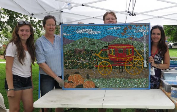 Grace Milliken of JFogg Social Inspirations, artist Lizz Van Saun of Kast Hill Studio and Paden Livingston and Jessica Fogg of JFogg Social Inspirations show off the first finished mosaic panel. It does look pretty mosaicy, if we do say so ourselves.
