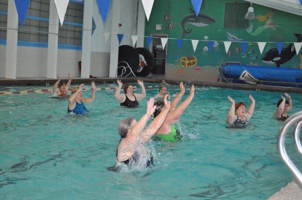 Merrill’s Thursday evening class raises the roof of the Health Club of Concord’s pool.
