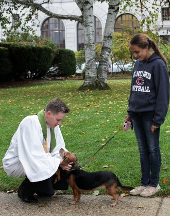 The Rev. Jason Wells of Grace Episcopal Church blessed Brooke Wheeler’s dog, Lola.
