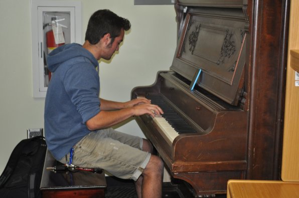 Nick Ackerson tickles the ivories, because tickling classmates is frowned upon at the college level.