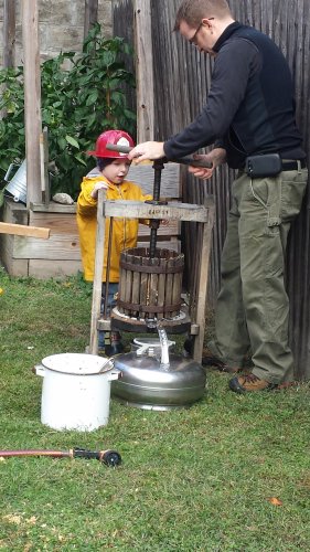 Will Allen with his son, Noah, making cider.