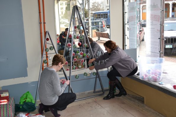 Ann Marie Finn and Susan Sokul work on the decorations, while Matt Teichman and Elyssa Paris craft it up in the mirror.