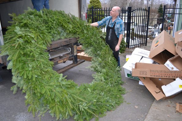 Cobblestone Design Company owner Brad Towne helps unload a 6-foot wreath. We can only speculate, but we believe it was purchased just so we could take this picture.