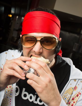 We call this artistic piece “Boloco employee as Elvis impersonator shoving a burrito in his face.” It’s avant garde. Or something. But now we want you to write the caption.. While you’re at it, you want to write the rest of the ones in the paper, too? We’re gonna go get some lunch.