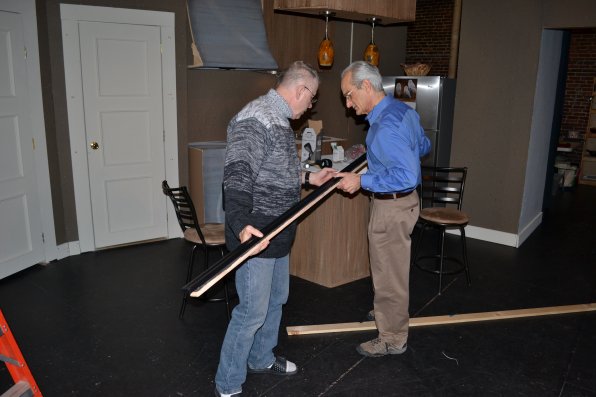 Wallace Pineault and Steven Meier work on the lighting for the Concord Community Players production of “The Tale of the Allergist’s Wife.”